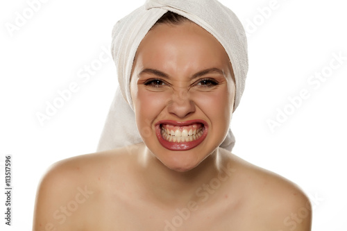 beautiful young woman with a towel on her head showing her teeth