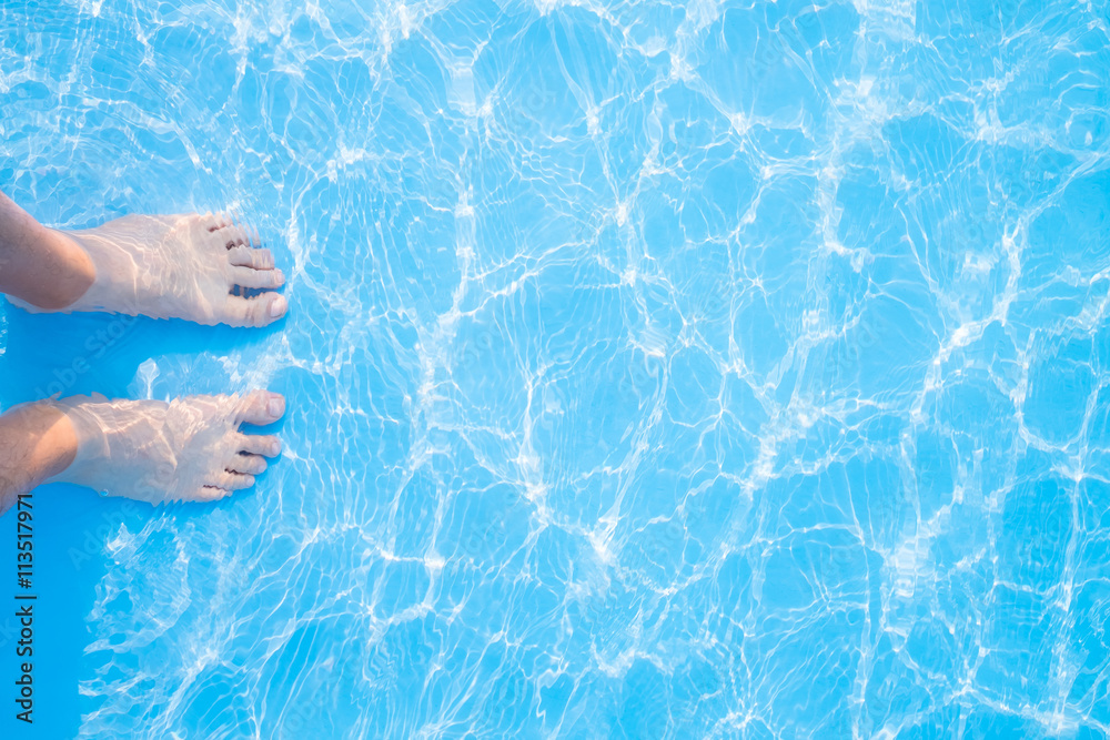 Barefoot and blue swimming pool