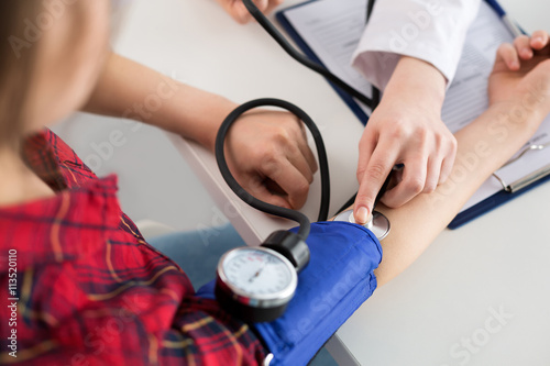 Close up view of doctor measuring blood pressure photo