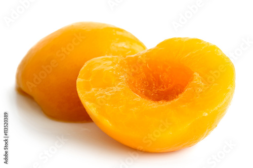Two peach halves isolated on white background.