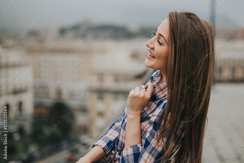 Young cute smiling lady posing in a beautiful city, italy, near ocean and mountains
