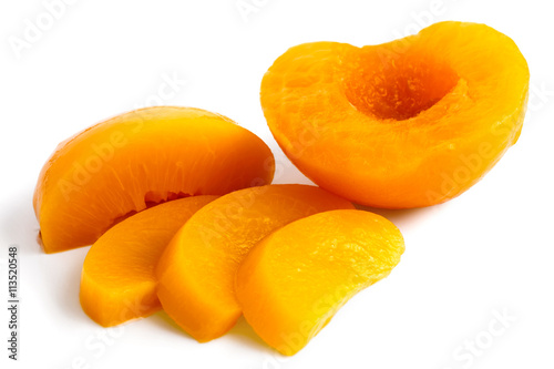 Peach half and slices isolated on white background.