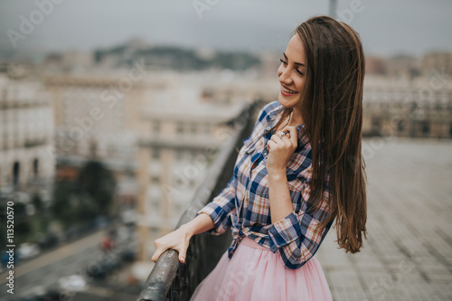 Young cute smiling lady posing in a beautiful city, italy, near ocean and mountains 