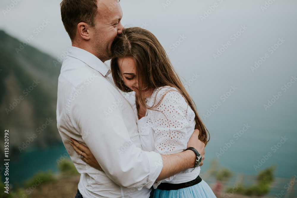 Young cute couple honeymoon walks holding their hands on dating in a beautiful place italy near ocean and mountains, hug, smile and talk to each other
Young cute couple honeymoon walks holding their hands on dating in a beautiful place italy near ocean and mountains, hug, smile and talk to each other