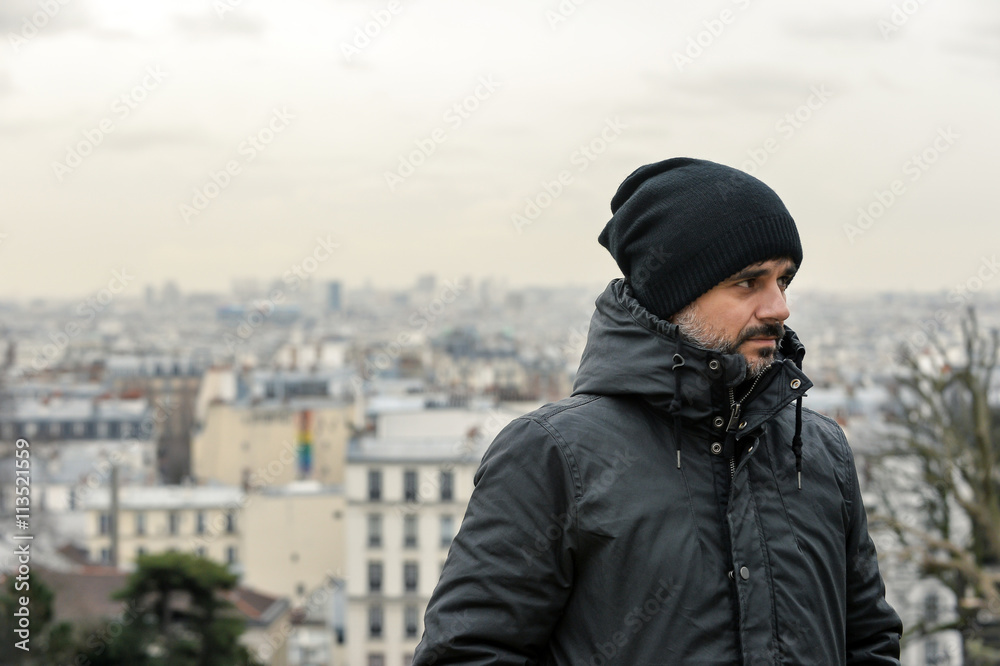 Man wearing a coat and a hut in Paris Man wearing a coat and a hut in Paris