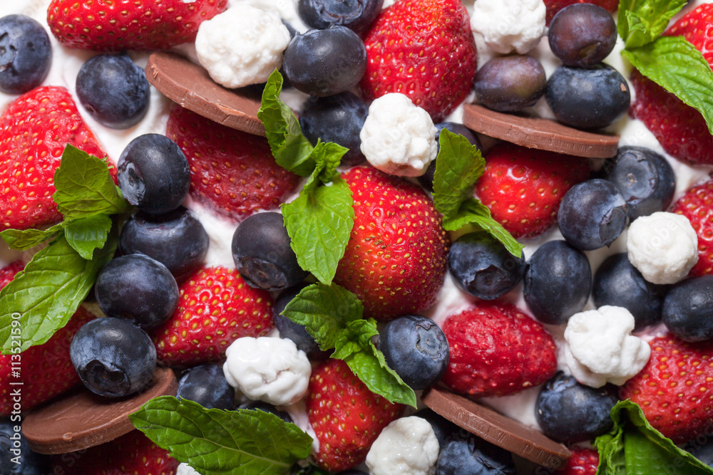 Biscuit homemade cake with cream and berries on black background Biscuit homemade cake with cream and berries on black background