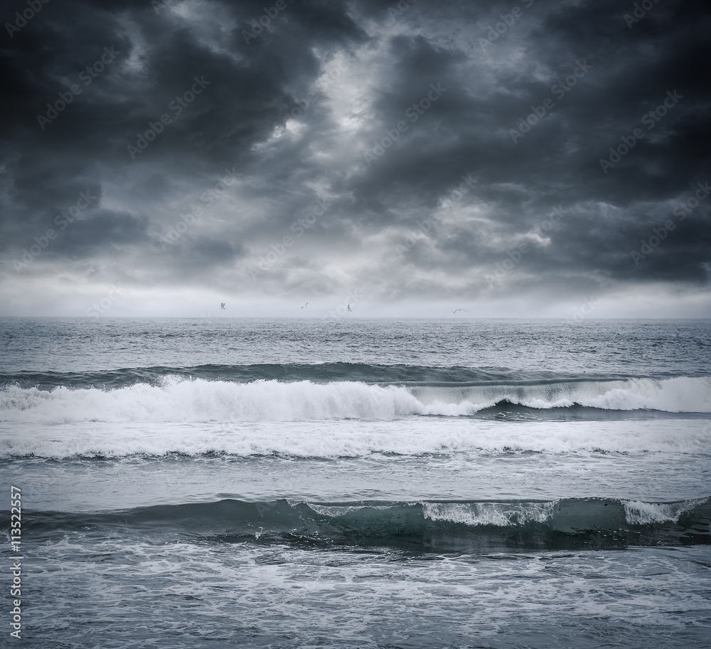 Dark stormy sky and sea waves.