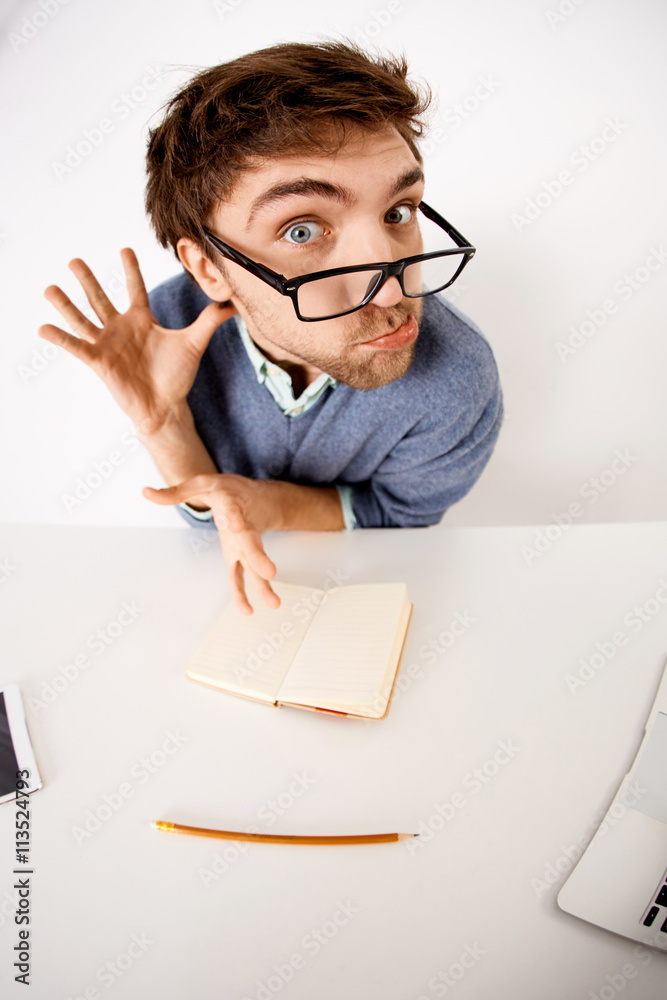 Crazy businessman chatting on his laptop and looking at camera Crazy businessman chatting on his laptop and looking at camera