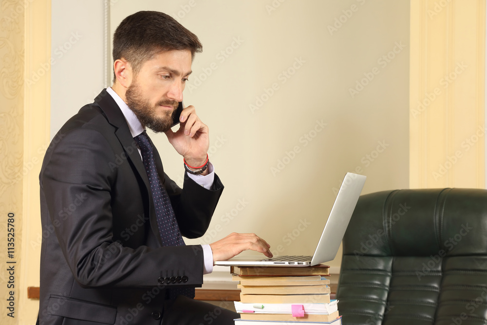 successful business man in office working with laptop