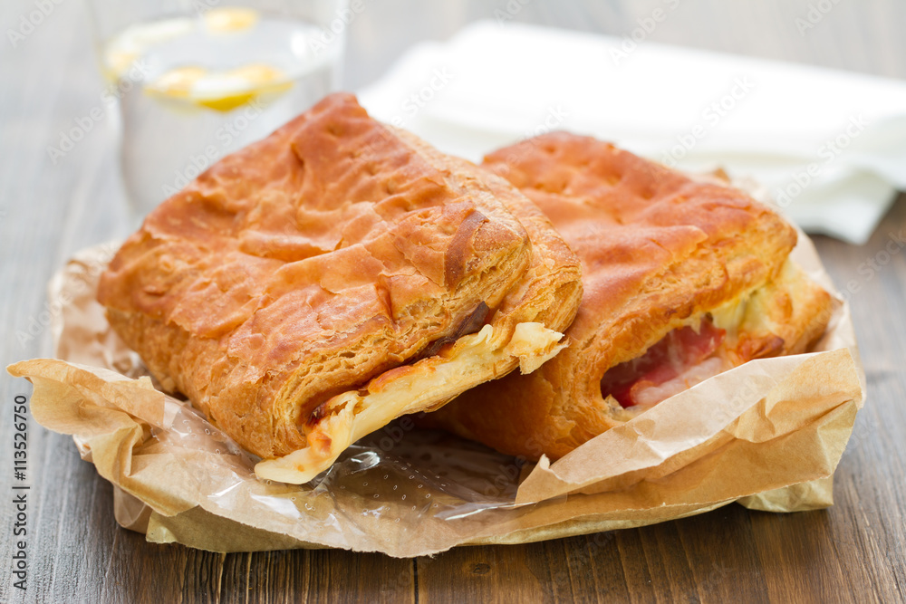 bread with ham and cheese with glass of water