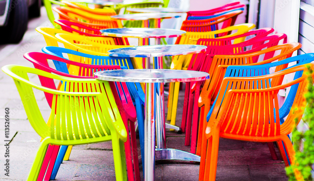 cafe summer terrace. cozy tables with red chairs