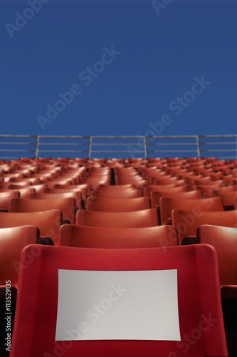 Stadium Seat on Blue Sky Background and Blank Paper at Front Seat