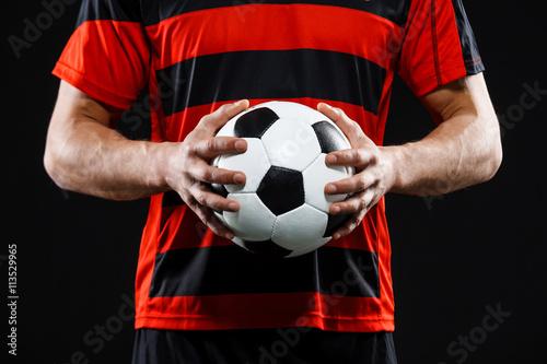 Close up of soccer ball in athlete's hands