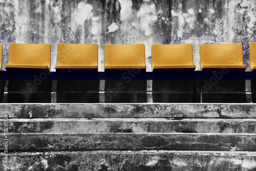 Canvas-taulu Plastic Seat with Grunge Dark Background / Plastic Chair with Grunge Dark Backgr