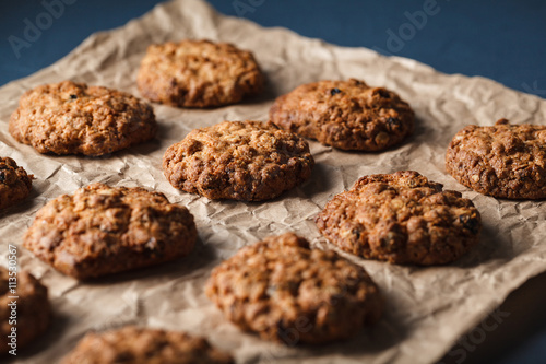 Cropped image of oatmeal cookies with nuts on a baking tray 