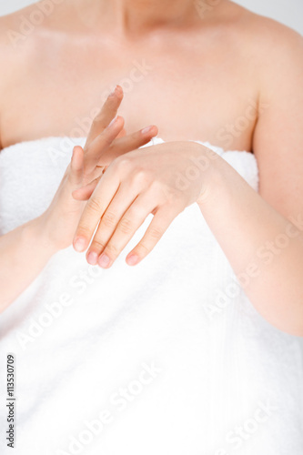 Close up of young girl in towel over white background.
