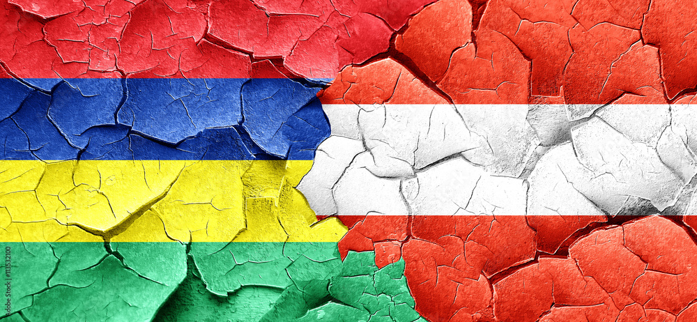Mauritius flag with Austria flag on a grunge cracked wall