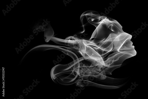 Double exposure portrait of woman and smoke.