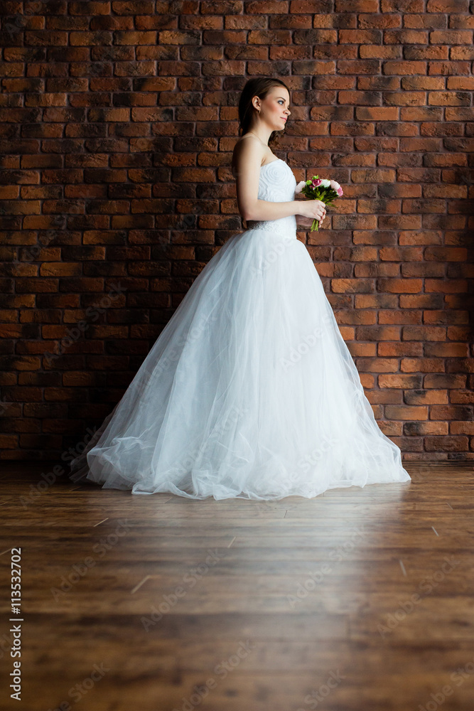 Young sexy bride in a studio standing next to the wall Young sexy bride in a studio standing next to the wall