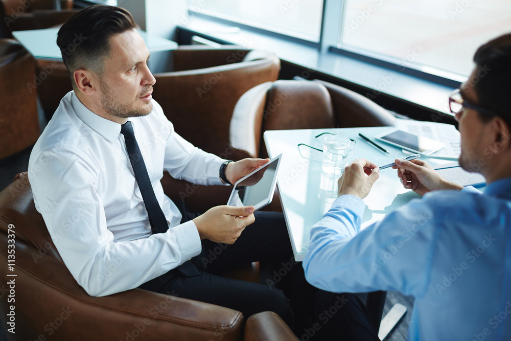 Pensive businessman with touchpad Pensive businessman with touchpad