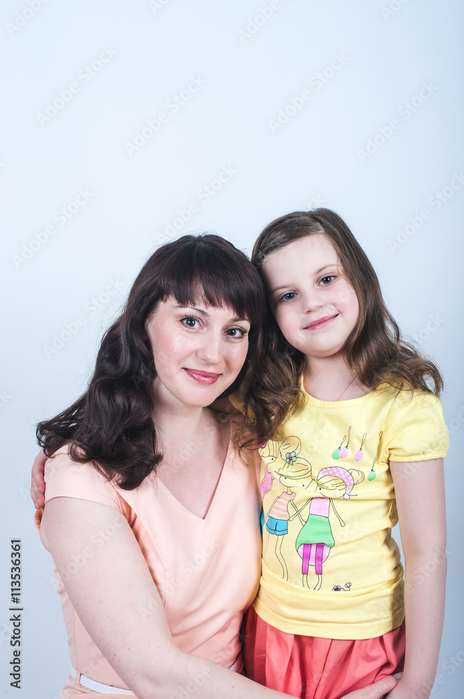 the daughter and mother together in each other's arms on a white background