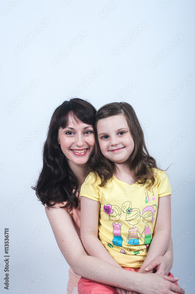 the daughter and mother together in each other's arms on a white background the daughter and mother together in each other's arms on a white background