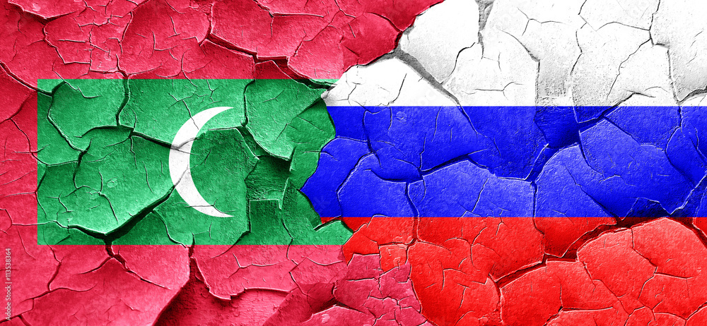 Maldives flag with Russia flag on a grunge cracked wall