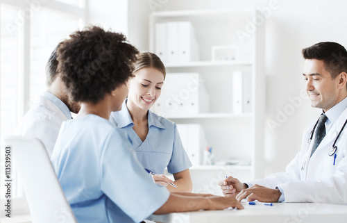 group of happy doctors meeting at hospital office