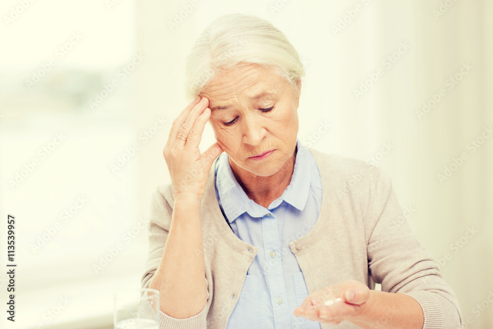 senior woman with water and medicine at home senior woman with water and medicine at home