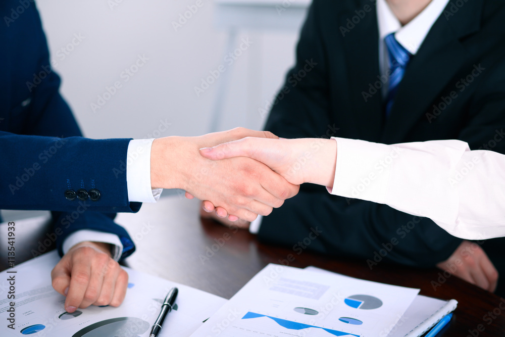 Business people shaking hands finishing up a meeting Business people shaking hands finishing up a meeting