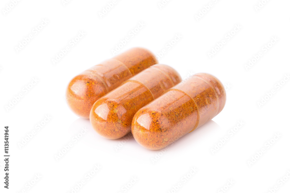 Turmeric powder inside a capsule isolated on white Turmeric powder inside a capsule isolated on white
