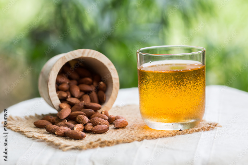 Cup of green tea with almonds placed close together. Cup of green tea with almonds placed close together.