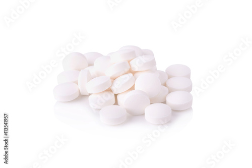 White pills on the white background