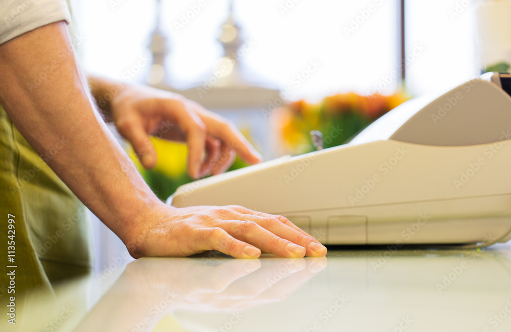 Fototapeta premium close up of man or seller at flower shop cashbox