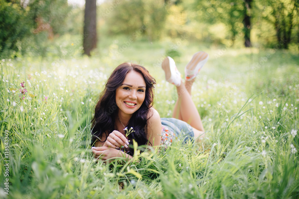 sunny summer day, a beautiful young woman lying on the grass sunny summer day, a beautiful young woman lying on the grass