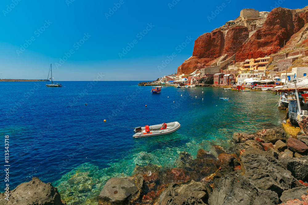 Fishing boats at Old port Ammoudi of Oia village at Santorini island in Aegean sea, Greece