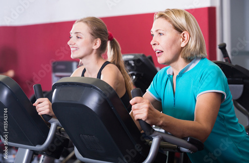 Women of different age training on exercycle