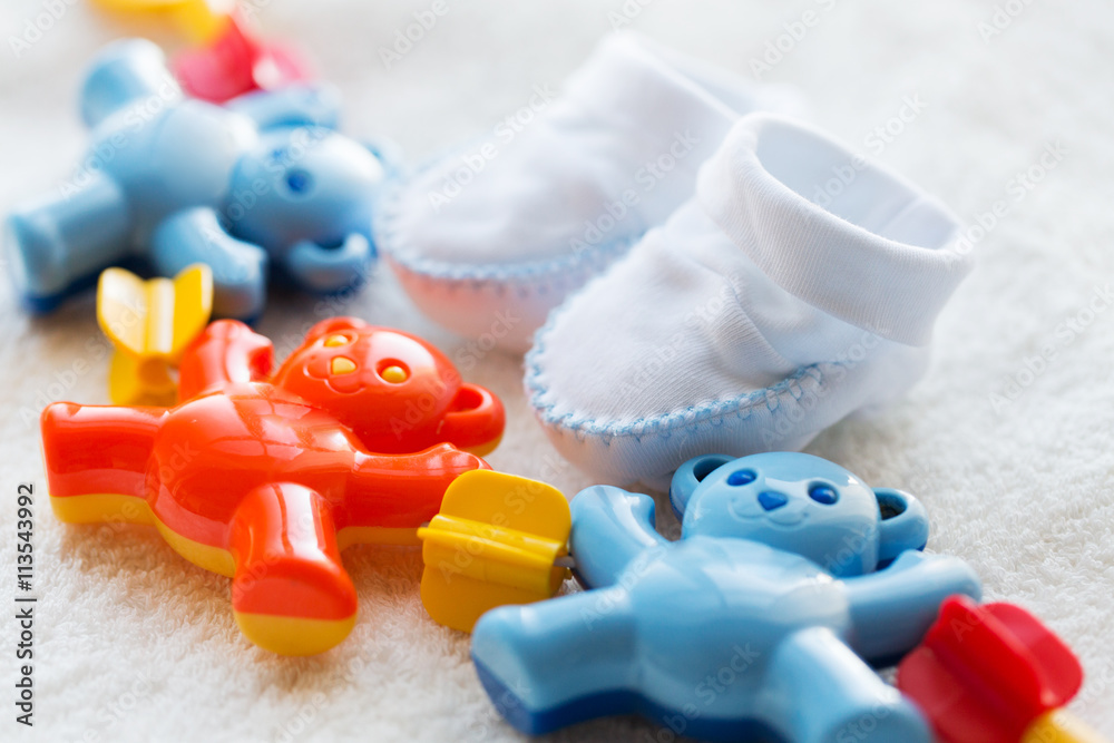 Fototapeta premium close up of baby rattle and bootees for newborn