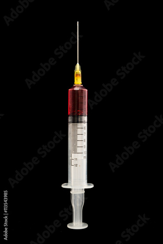 Syringe with blood on a black background
