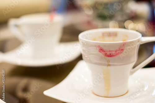 Soft focus of woman lipstick mark on cup of coffee