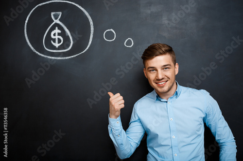 Portrait of minded man pointing on his mind about money