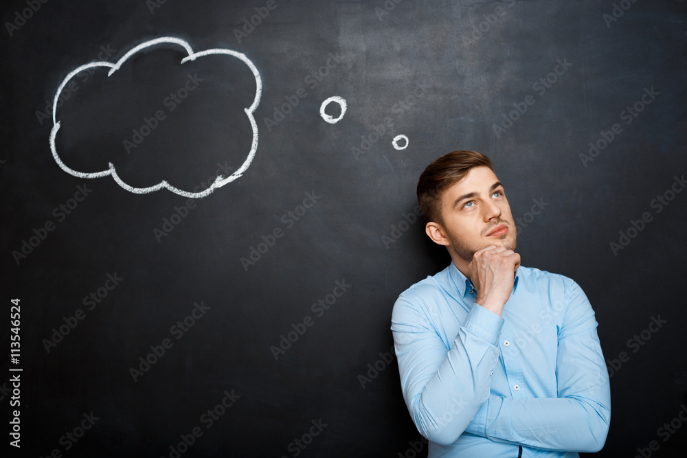 Confused bearded man shouting and standing on blackboard backgro Confused bearded man shouting and standing on blackboard backgro