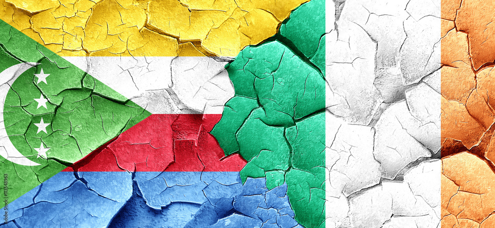 Comoros flag with Ireland flag on a grunge cracked wall Comoros flag with Ireland flag on a grunge cracked wall