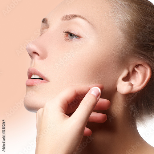 Beautiful face of young woman with clean fresh skin. Portrait of