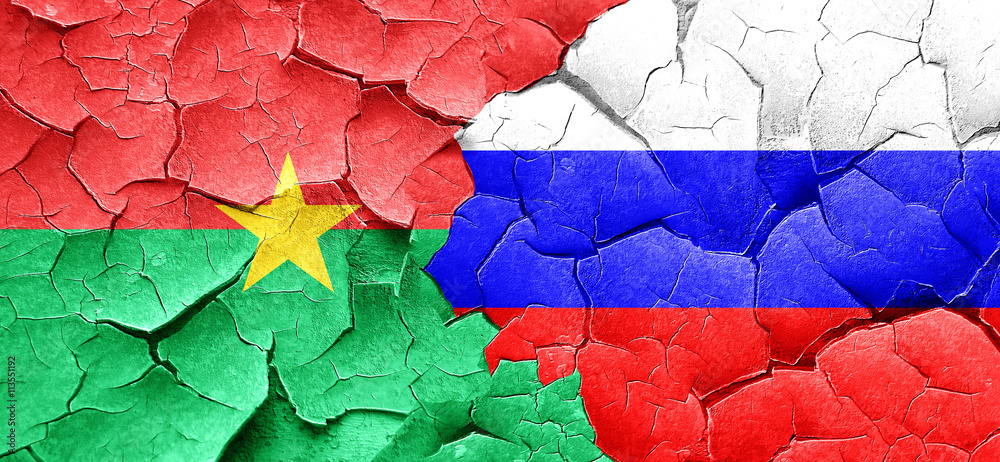 Burkina Faso flag with Russia flag on a grunge cracked wall