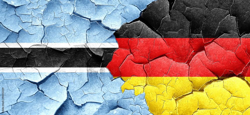 Botswana flag with Germany flag on a grunge cracked wall