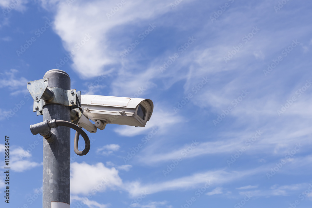 Close circuit camera,The close circuit camera on the pole with the blue sky background.The security system from the close-circuit camera with the sky. Close circuit camera,The close circuit camera on the pole with the blue sky background.The security system from the close-circuit camera with the sky.