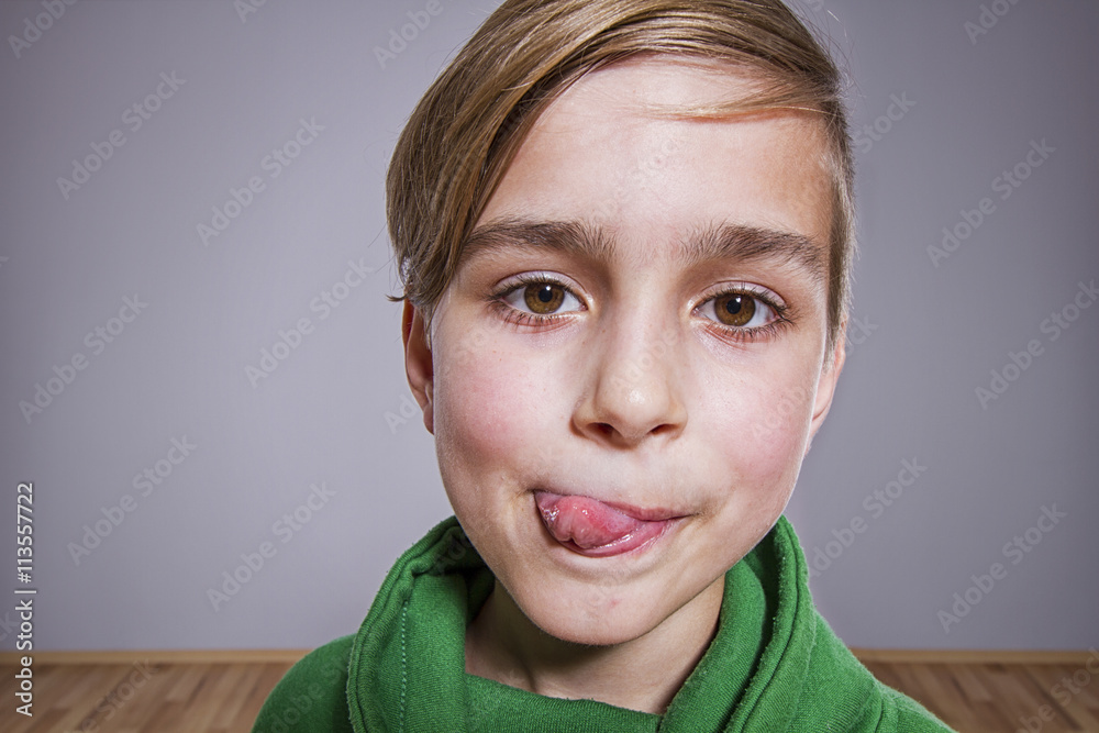 boy with tongue out licking his lips, funny portrait Stock Photo