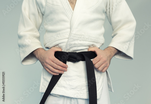 Martial arts Master with black belt in white kimono
