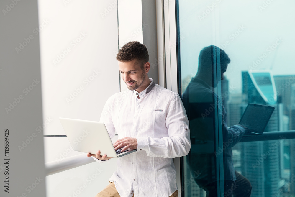 Businessman typing on laptop.

